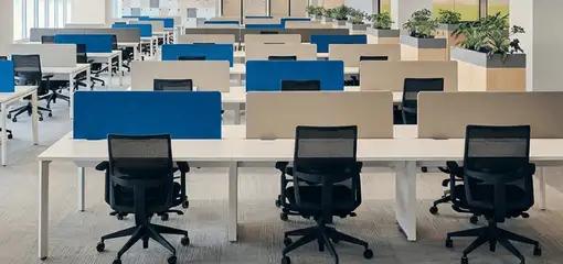 Modern open-plan office space featuring clean workstations, ergonomic chairs, and sanitized carpets provided by professional office cleaning services in Little Rock, AR.