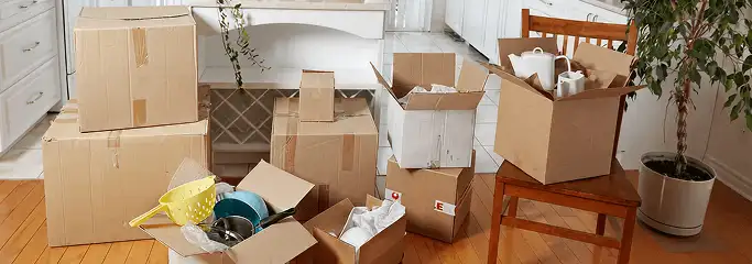 Packed moving boxes and household items in a kitchen before move-out or move-in cleaning, Little Rock, AR.